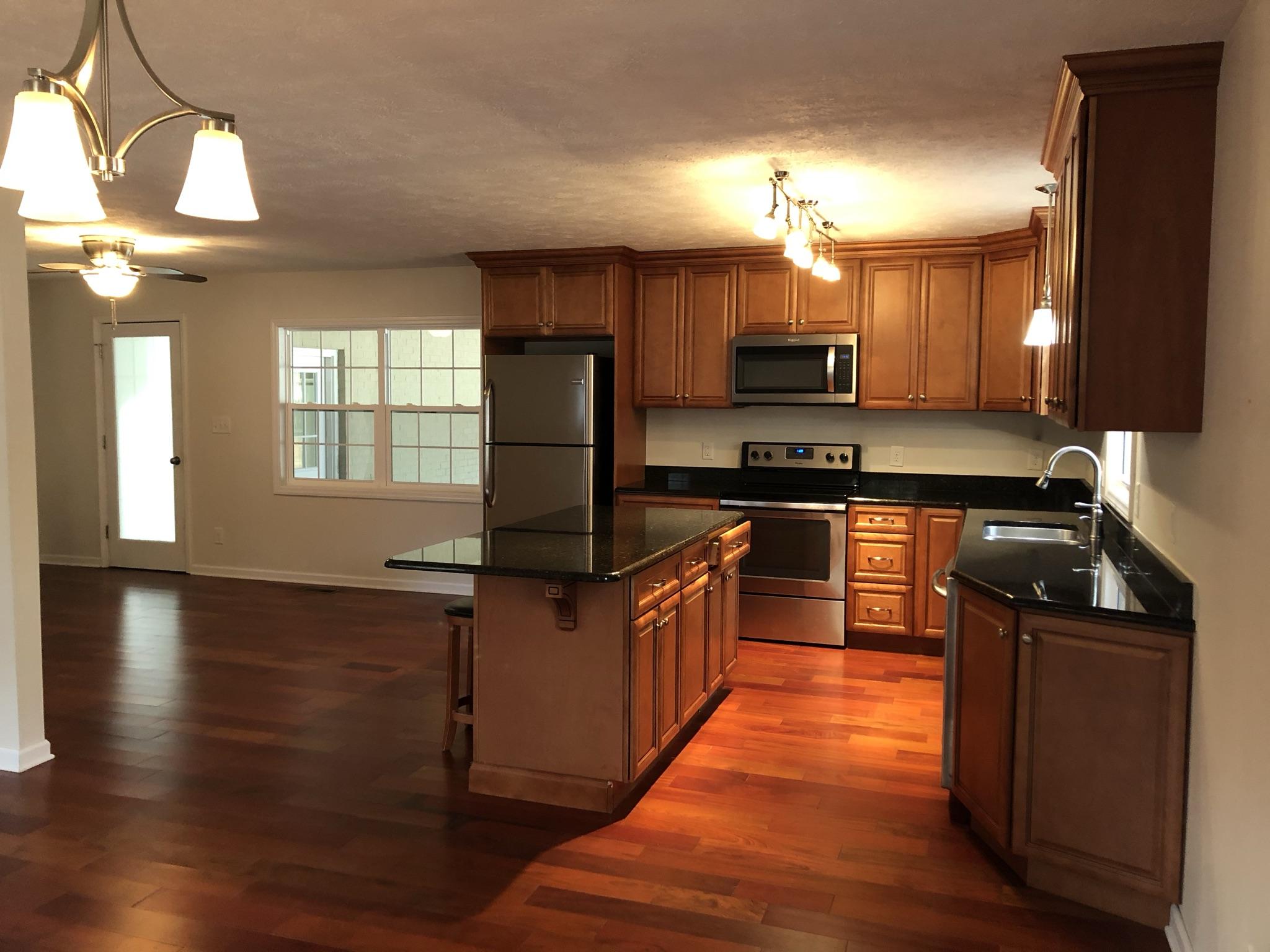 905 Robinwood Road Aberdeen, NC 28315 - Photo 37 of 42 Beautiful cherry colored floors throughout with elegant cabinetry