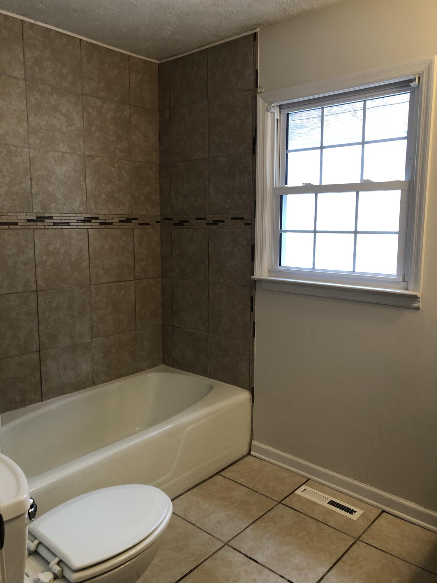 905 Robinwood Road Aberdeen, NC 28315 - Photo 7 of 42 hall bath has a tiled tub surround and tile floors
