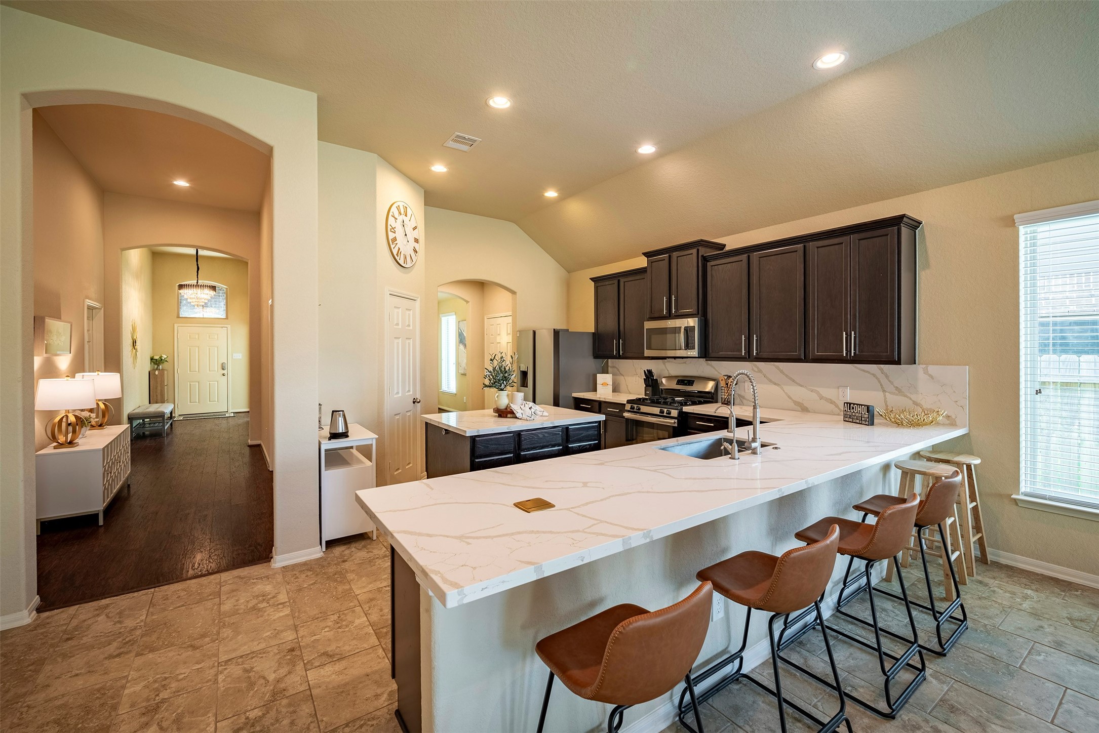 4423 Hidden Oaks Way Houston, TX 77084 - Photo 11 of 29 a kitchen with a dining table chairs and refrigerator