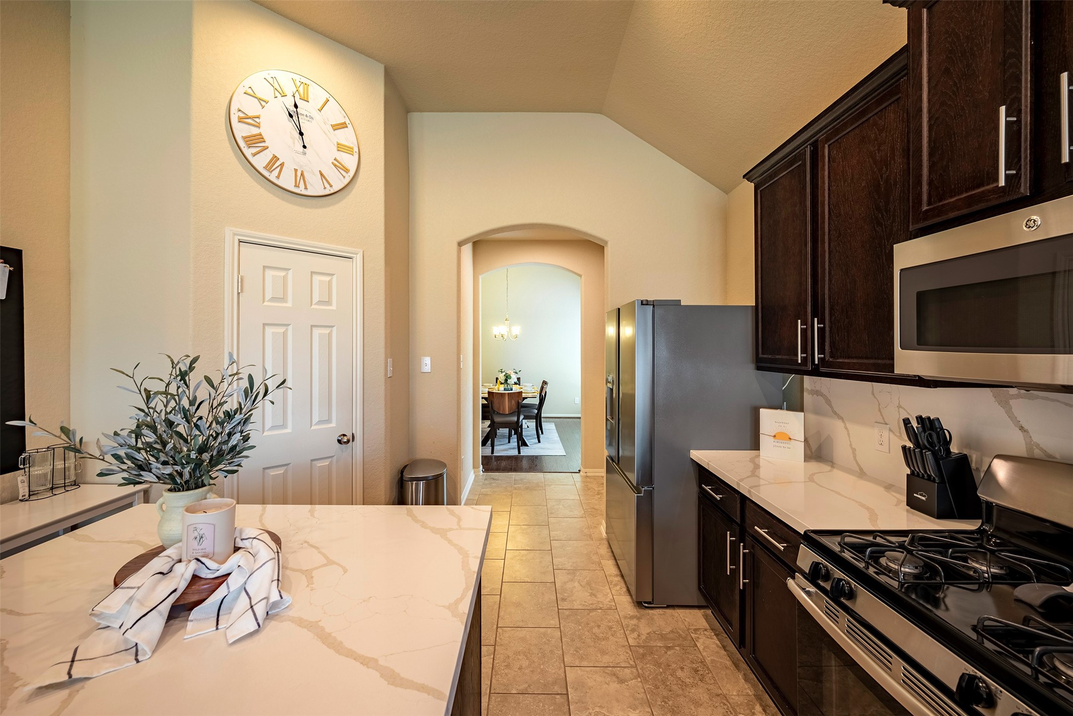 4423 Hidden Oaks Way Houston, TX 77084 - Photo 12 of 29 a kitchen with stainless steel appliances a stove a refrigerator and a microwave