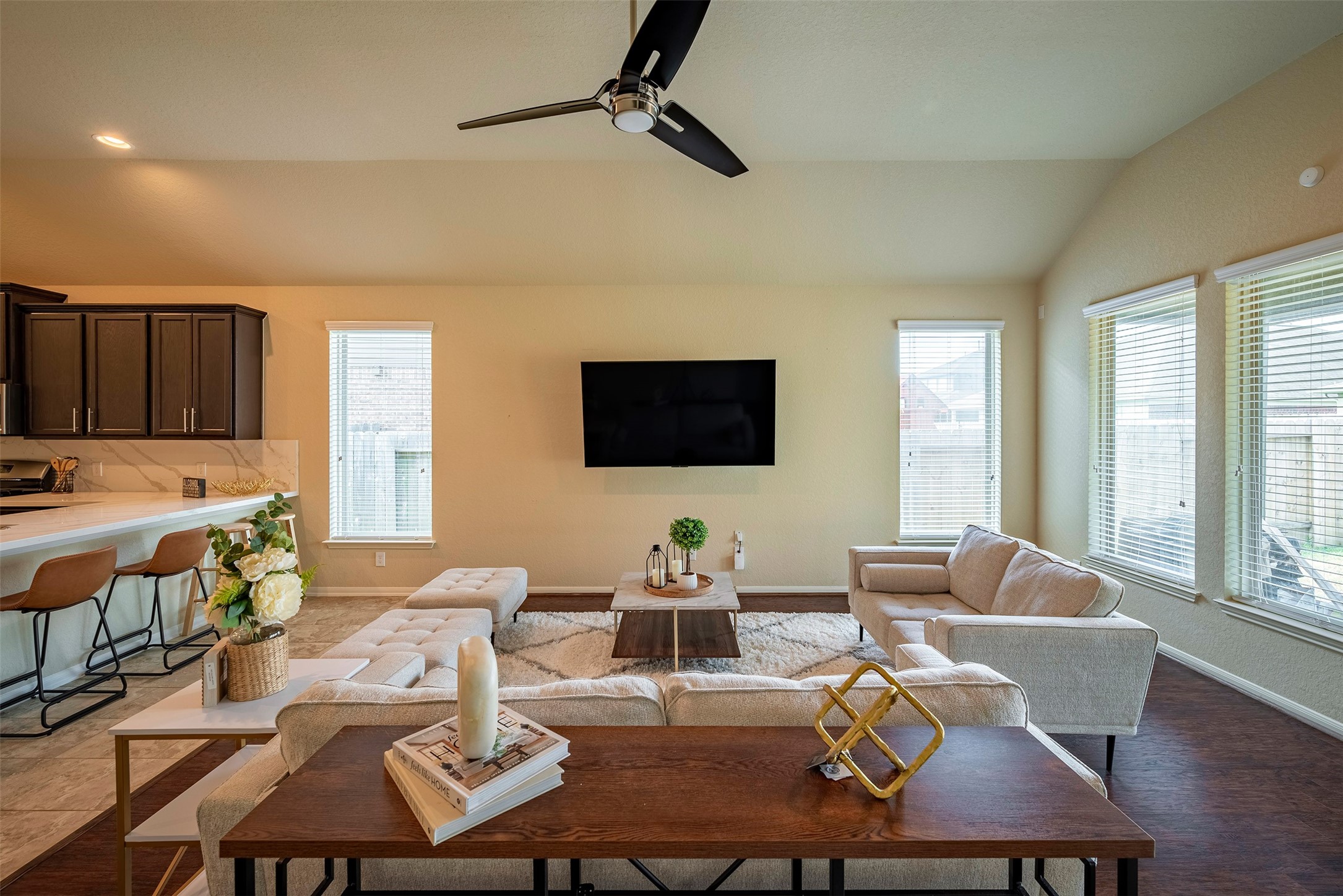 4423 Hidden Oaks Way Houston, TX 77084 - Photo 8 of 29 a living room with furniture a flat screen tv and a table