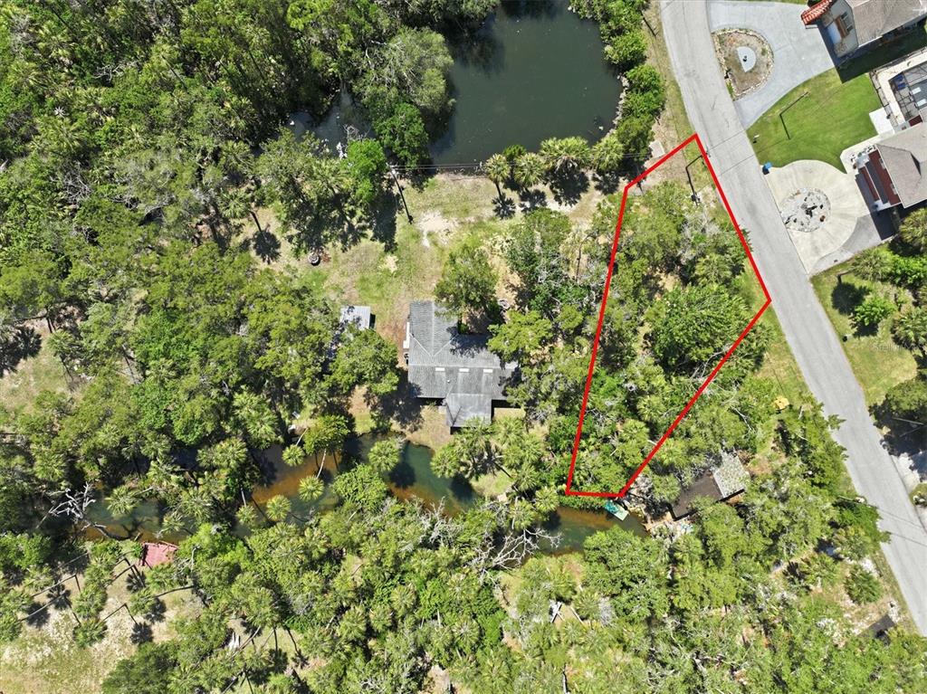 6240 Colony Circle Weeki Wachee, FL 34607 - Photo 8 of 15 an aerial view of a house with a yard and lake view