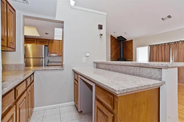 a kitchen with stainless steel appliances granite countertop a refrigerator stove and microwave
