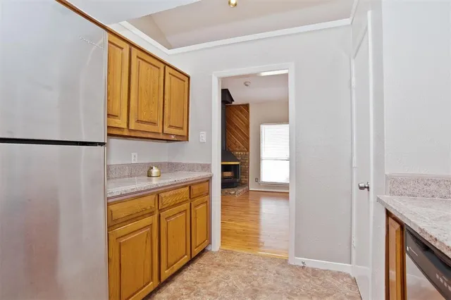a view of an empty room with window and fire place