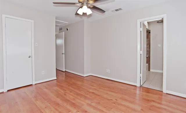 a bathroom with a granite countertop toilet a sink and a mirror