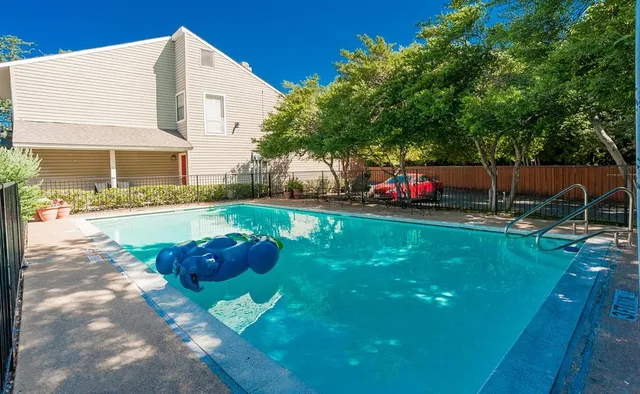 a front view of a house with a yard and mountain view
