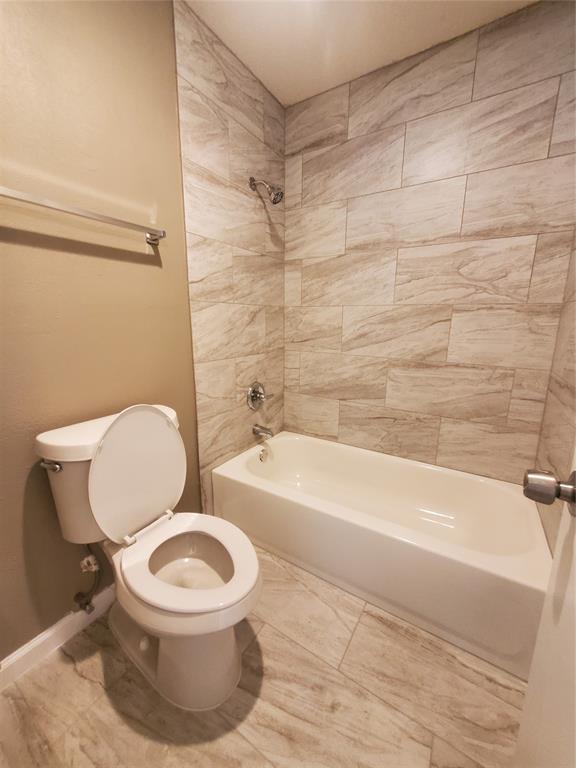 117 Valley Spring Drive Arlington, TX 76018 - Photo 5 of 9 a white toilet sitting next to a bath tub and a shower