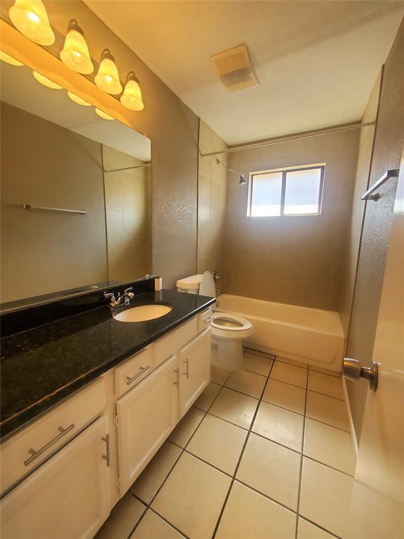 117 Valley Spring Drive Arlington, TX 76018 - Photo 6 of 9 a bathroom with a granite countertop sink a toilet and mirror