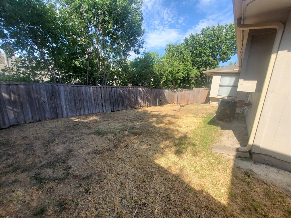 117 Valley Spring Drive Arlington, TX 76018 - Photo 8 of 9 a view of backyard with tree