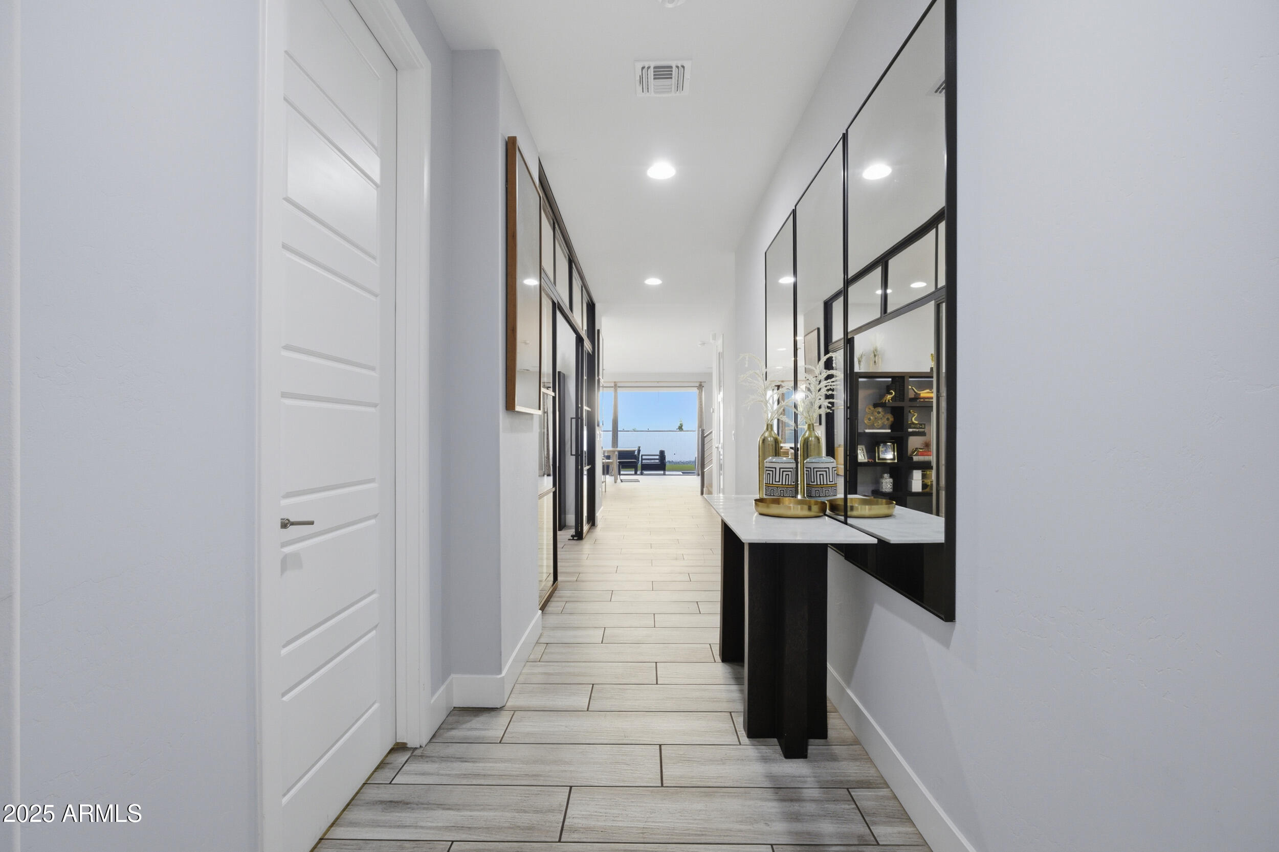 630 West Deer Creek Road Phoenix, AZ 85048 - Photo 12 of 47 a hallway with white cabinets and black appliances