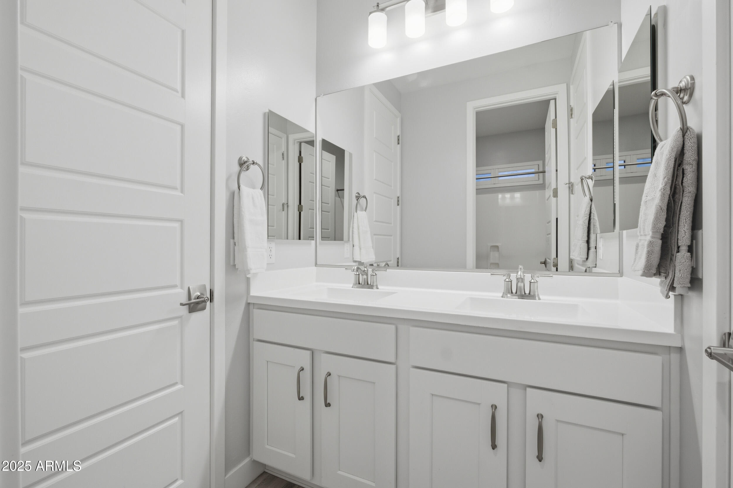 630 West Deer Creek Road Phoenix, AZ 85048 - Photo 23 of 47 a bathroom with a double vanity sink and mirror