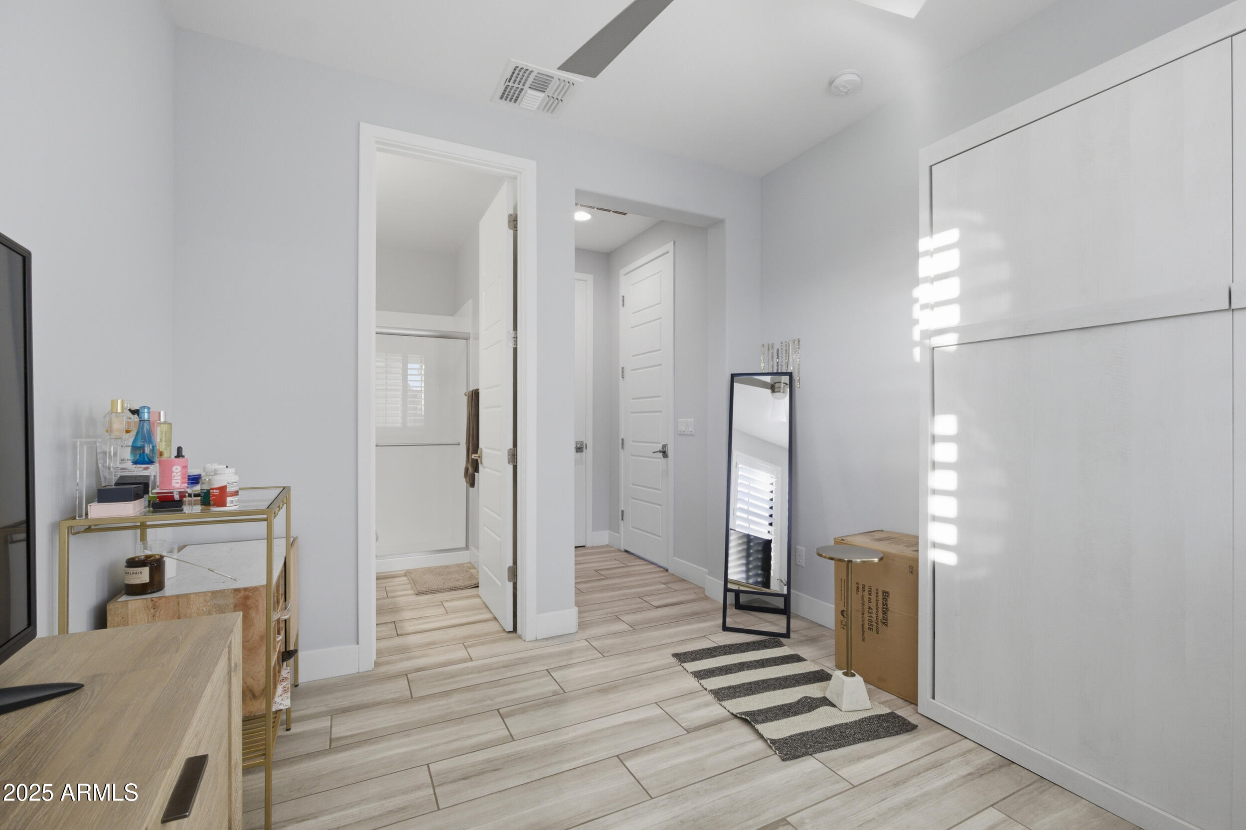 630 West Deer Creek Road Phoenix, AZ 85048 - Photo 26 of 47 a view of a hallway with wooden floor and a bathroom