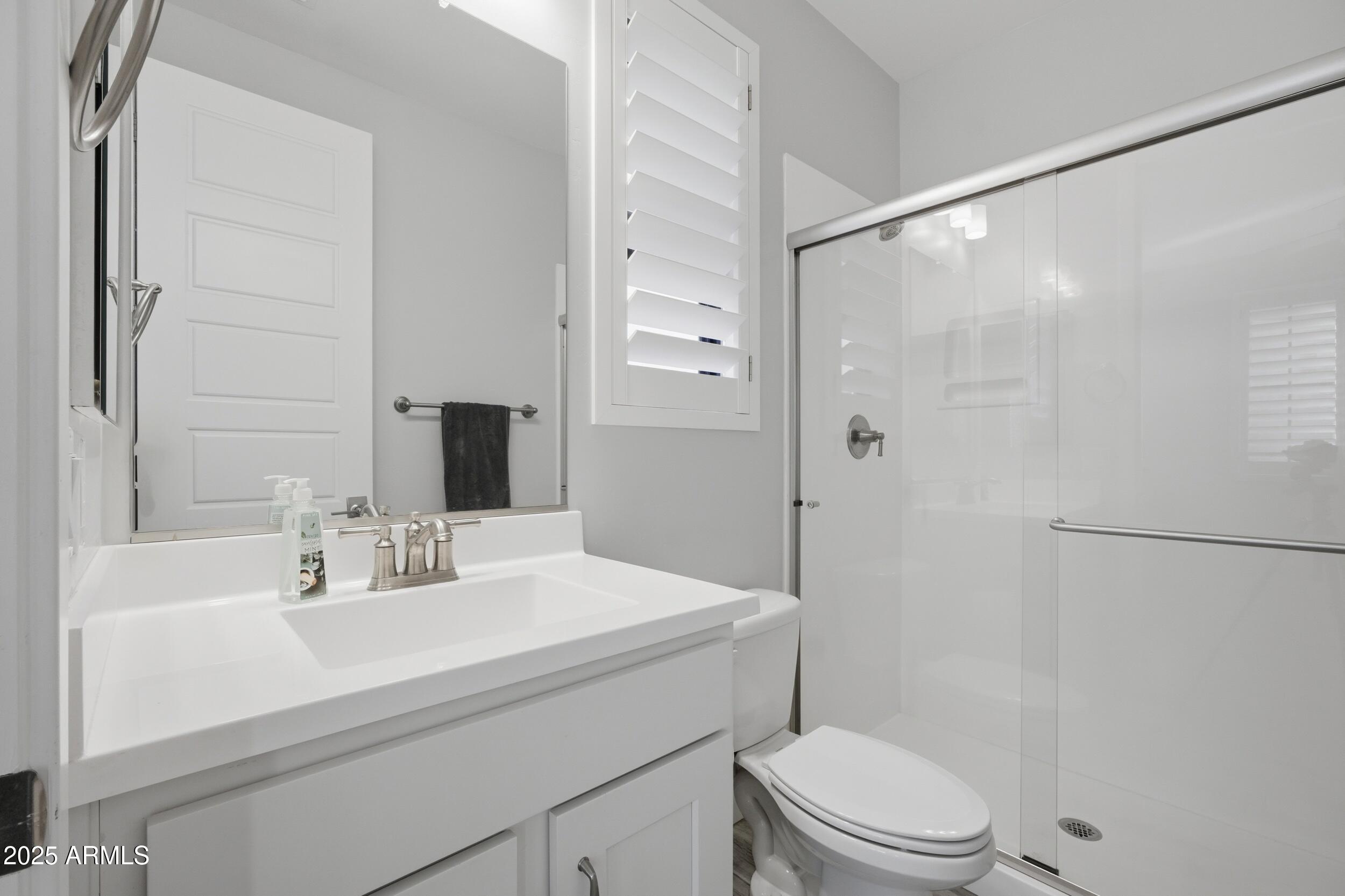 630 West Deer Creek Road Phoenix, AZ 85048 - Photo 27 of 47 a bathroom with a sink a mirror a toilet and shower