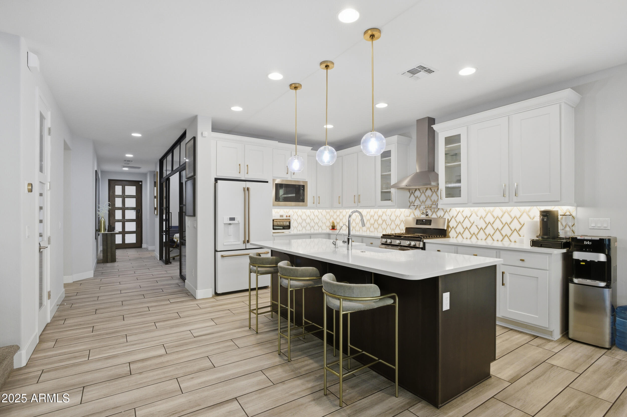 630 West Deer Creek Road Phoenix, AZ 85048 - Photo 3 of 47 a kitchen with stainless steel appliances granite countertop a sink a stove a refrigerator and island with wooden floor