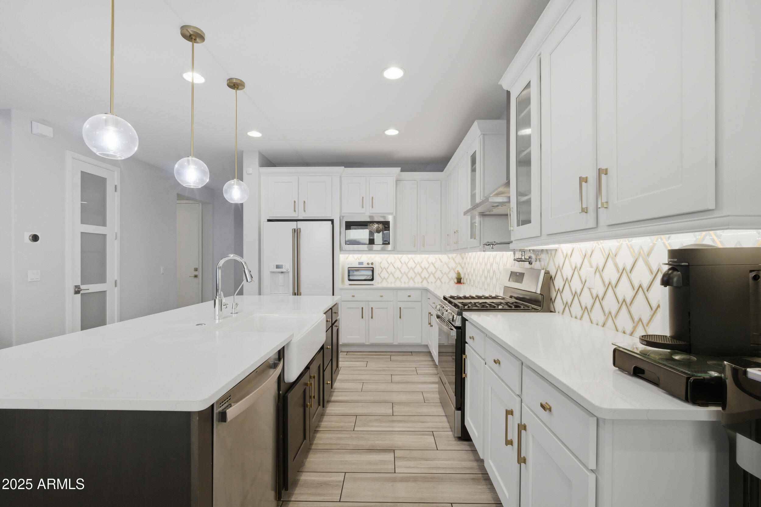 630 West Deer Creek Road Phoenix, AZ 85048 - Photo 8 of 47 a kitchen with a sink a counter top space stainless steel appliances and cabinets
