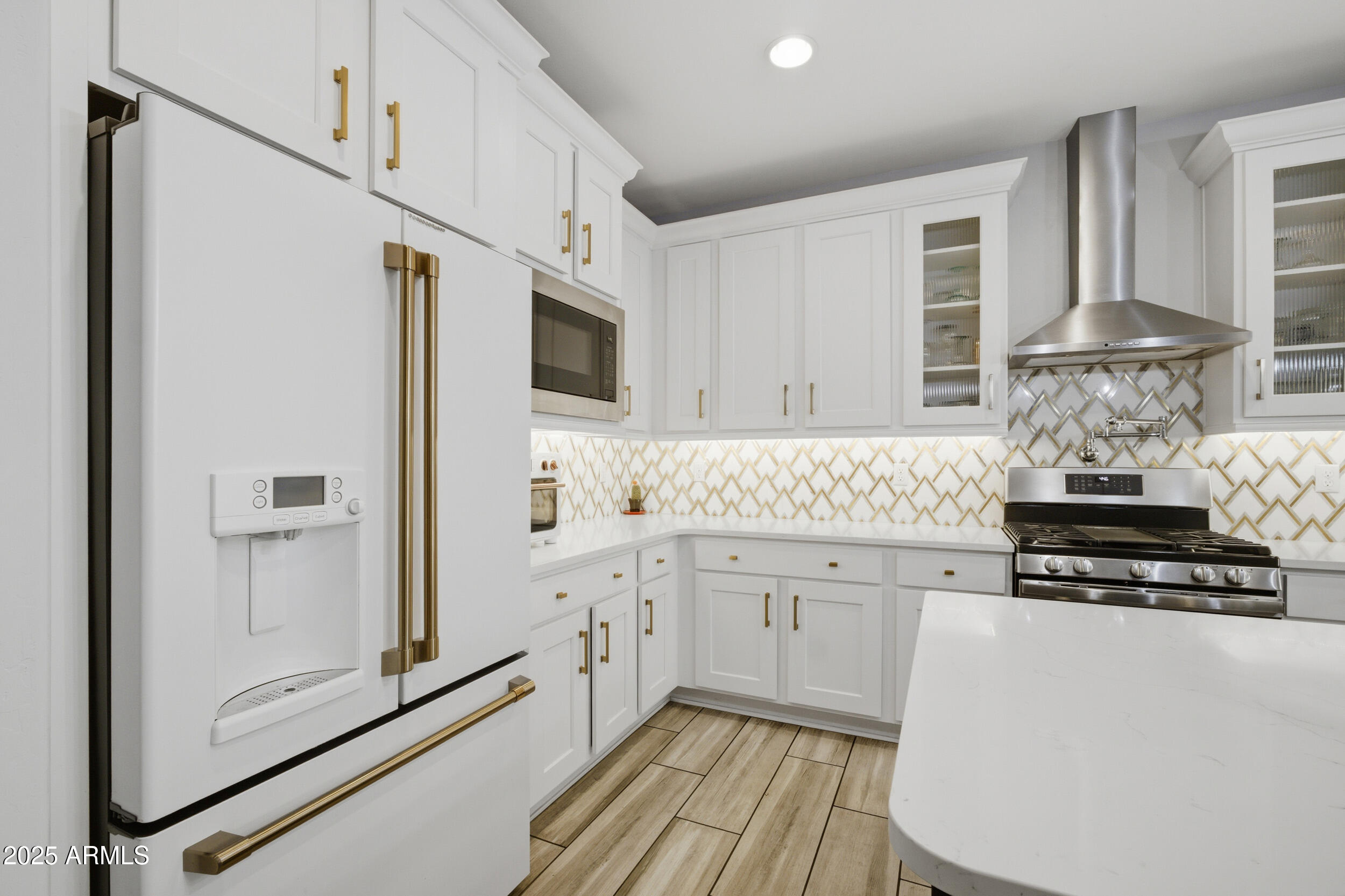 630 West Deer Creek Road Phoenix, AZ 85048 - Photo 9 of 47 a kitchen with granite countertop white cabinets and white appliances