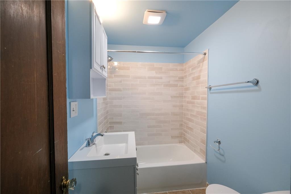 1326 Woodland Avenue Pittsburgh, PA 15212 - Photo 11 of 16 a bathroom with a bathtub a sink a toilet and a shower