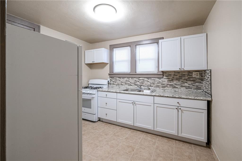 1326 Woodland Avenue Pittsburgh, PA 15212 - Photo 6 of 16 a bathroom with a granite countertop sink and a vanity