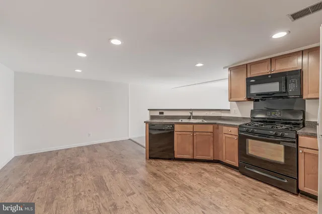 a kitchen with stainless steel appliances granite countertop a stove and a sink