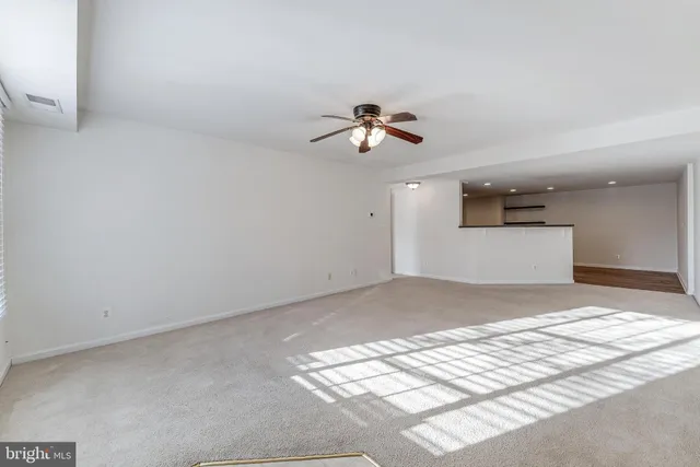 a view of a kitchen with a sink and a chandelier fan