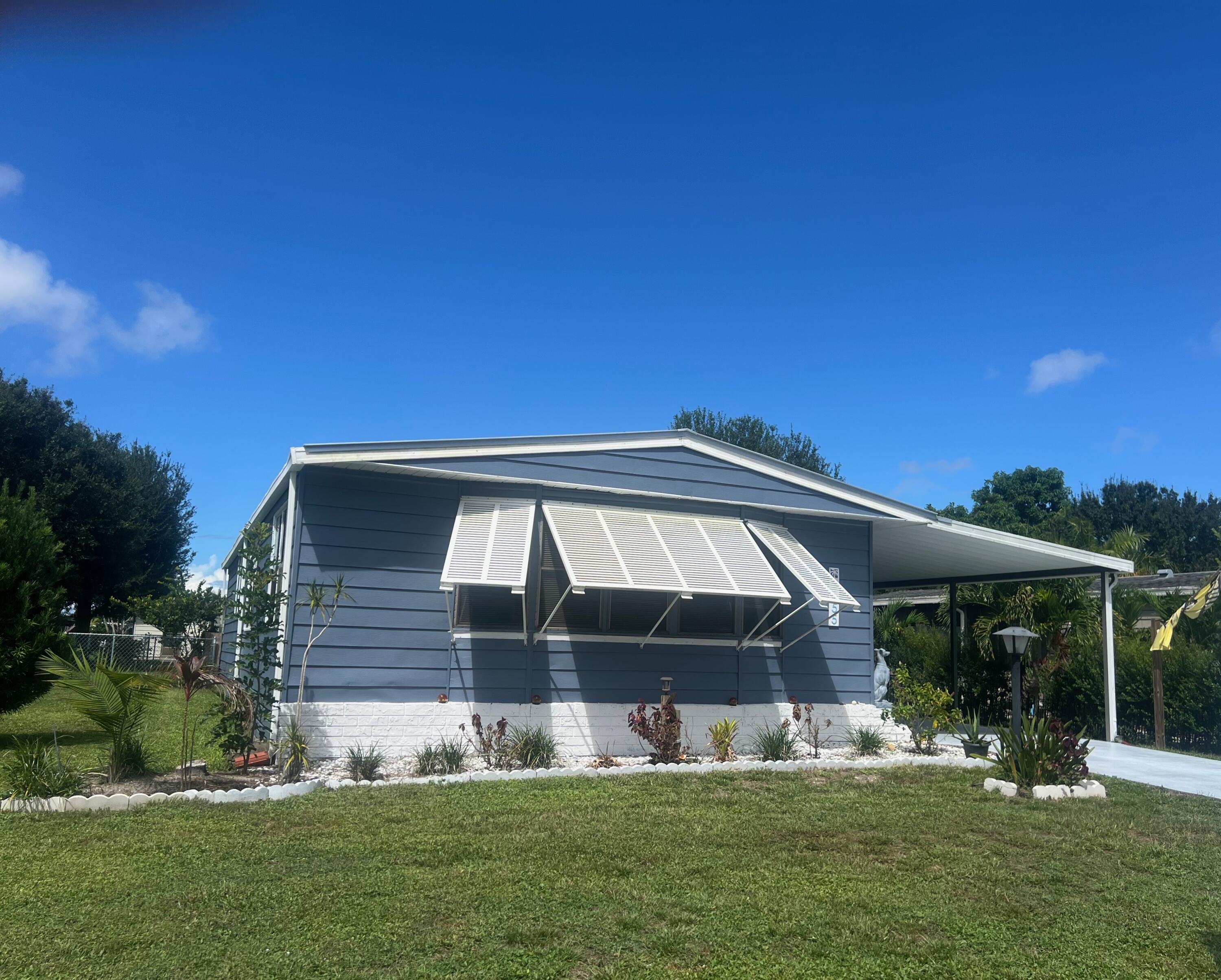 a front view of house with yard slide and outdoor seating