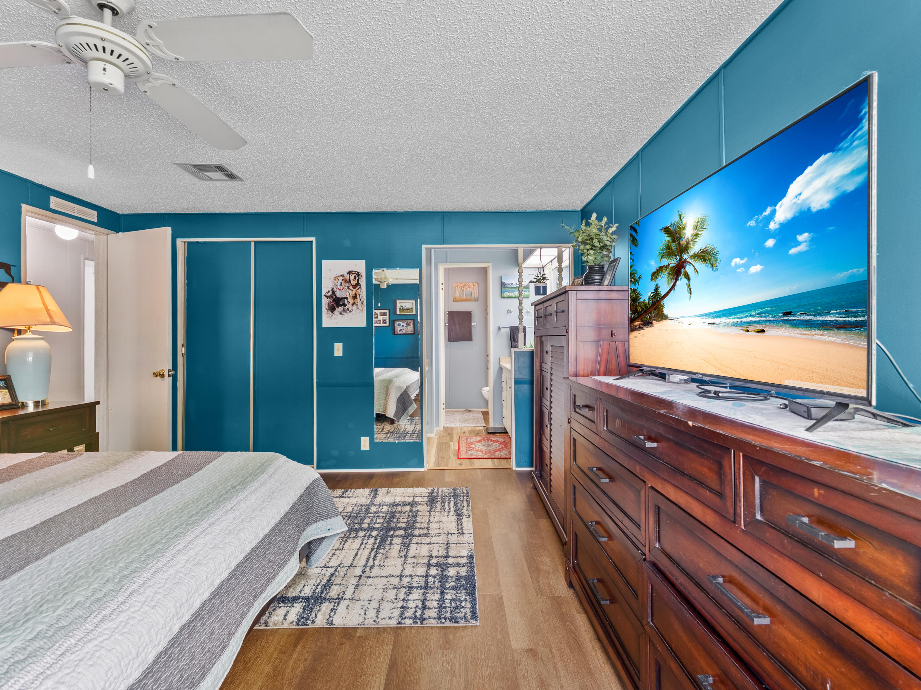 2855 Southwest Monarch Trail Stuart, FL 34997 - Photo 13 of 29 a bedroom with a large bed and a dresser