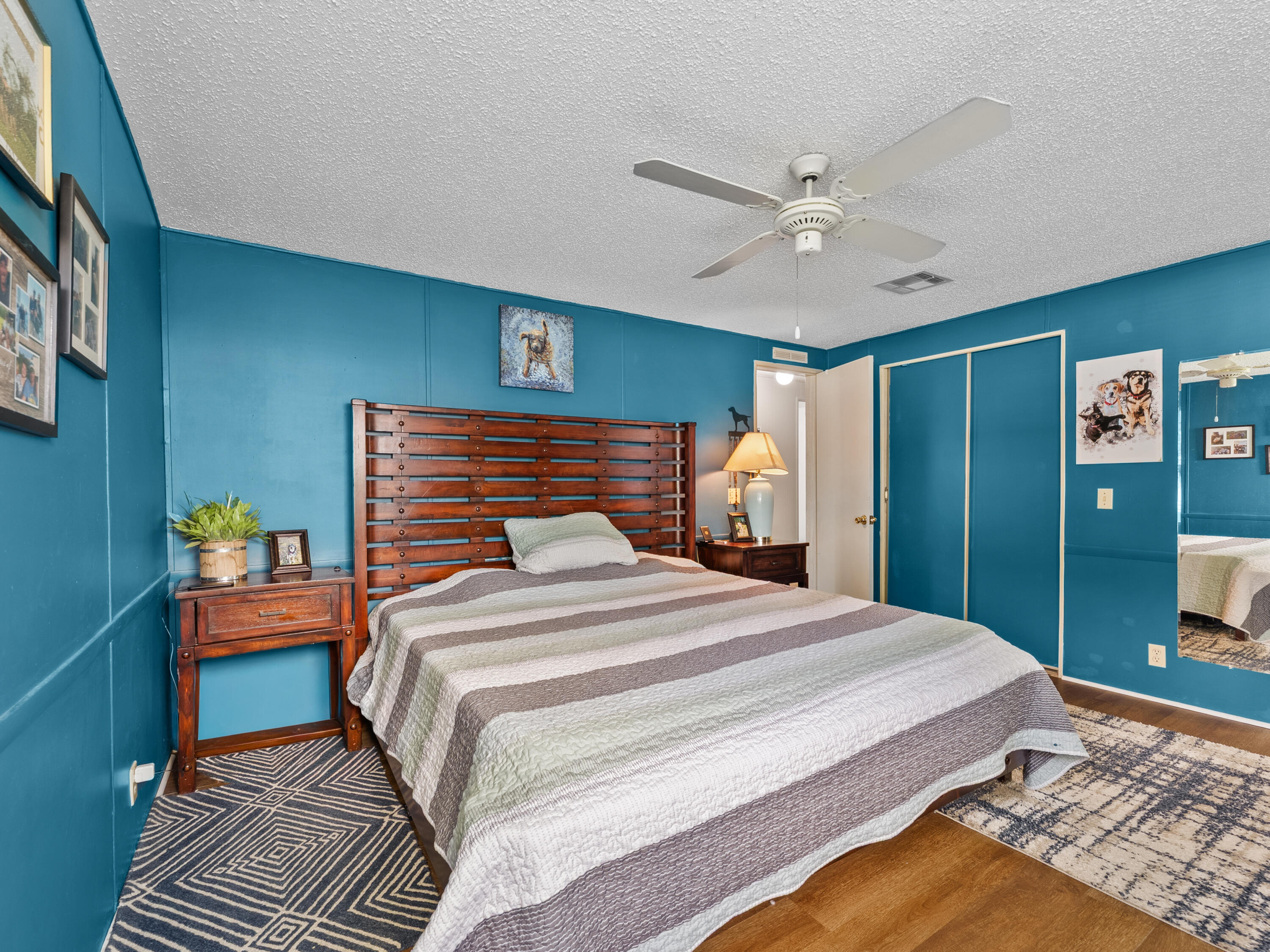 2855 Southwest Monarch Trail Stuart, FL 34997 - Photo 14 of 29 a bedroom with a bed and a chandelier