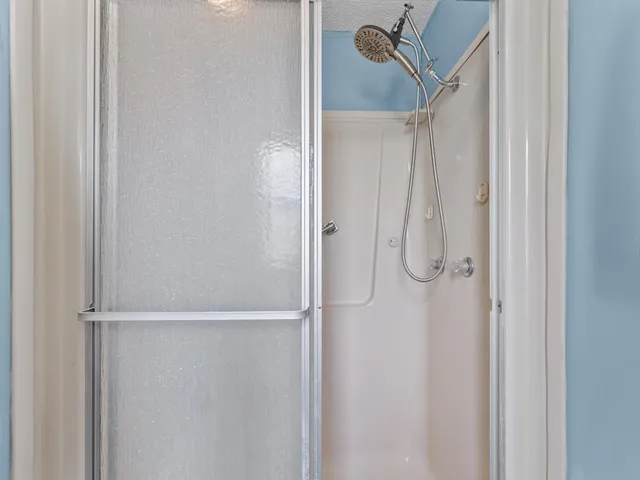 a bathroom with a glass shower door