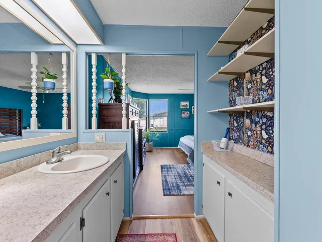 a en suite bathroom with a sink double vanity and shower