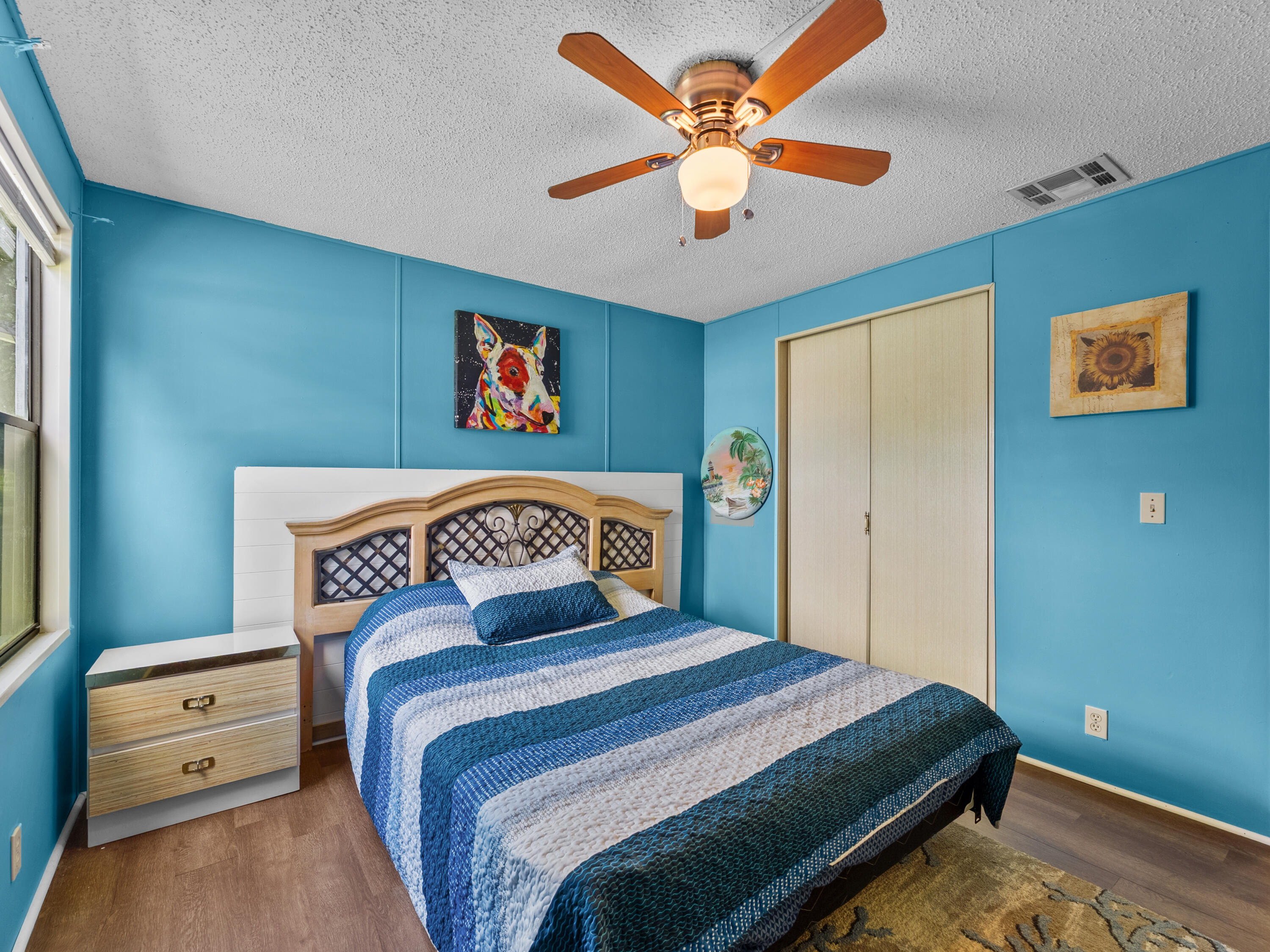 2855 Southwest Monarch Trail Stuart, FL 34997 - Photo 20 of 29 a bedroom with a bed and a chandelier