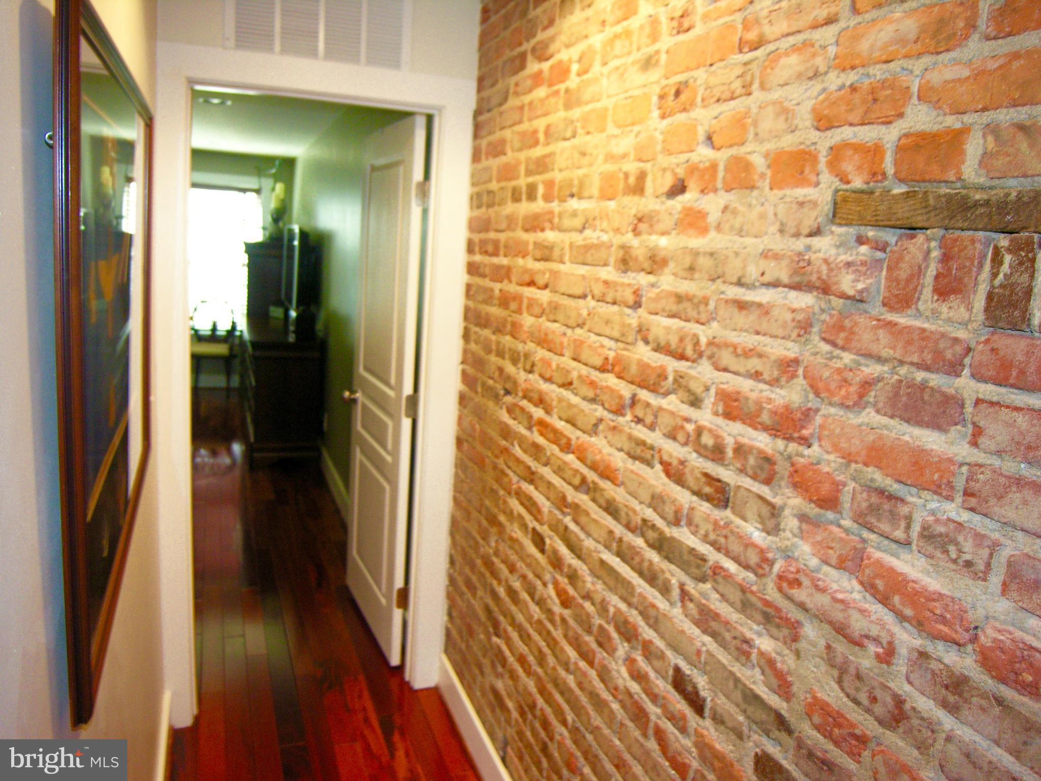 243 17th Street Southeast Washington, DC 20003 - Photo 23 of 26 Brick Walled Hallway to Master Bedroom