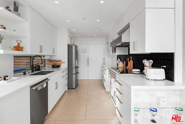 a kitchen with stainless steel appliances granite countertop a sink and cabinets