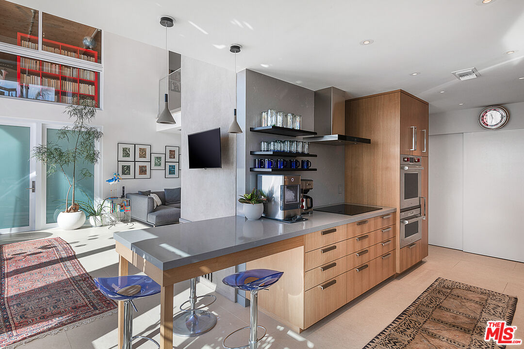 31201 Bailard Road Malibu, CA 90265 - Photo 14 of 56 a kitchen with stainless steel appliances kitchen island granite countertop a refrigerator and a stove top oven