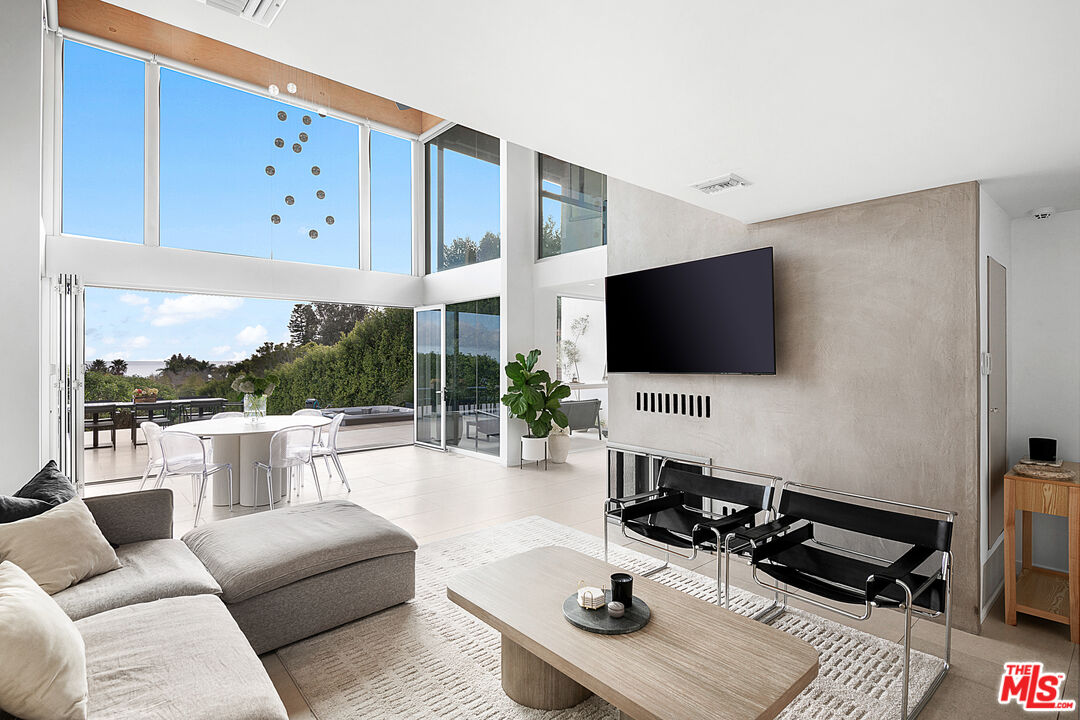 31201 Bailard Road Malibu, CA 90265 - Photo 20 of 56 a living room with furniture flat screen tv and a view of kitchen