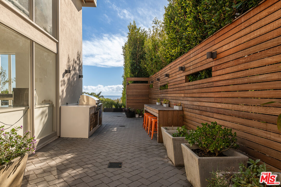 31201 Bailard Road Malibu, CA 90265 - Photo 40 of 56 a view of a patio with couches and potted plants