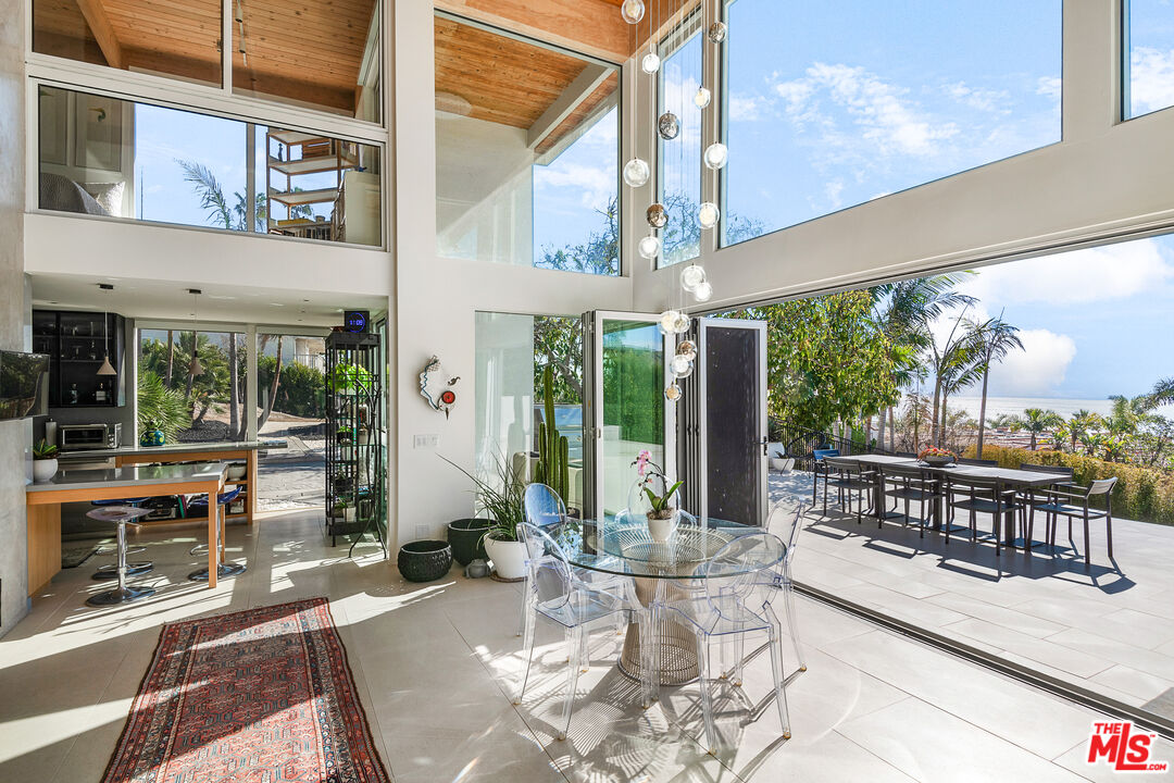 31201 Bailard Road Malibu, CA 90265 - Photo 7 of 56 a view of a patio with a dining table and chairs