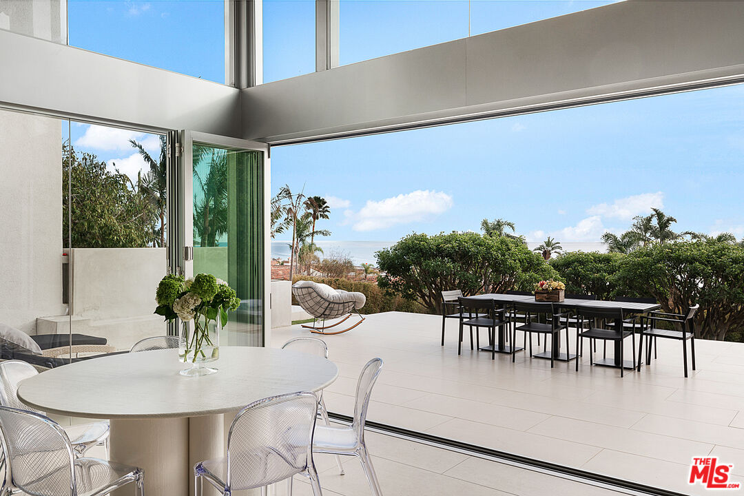 31201 Bailard Road Malibu, CA 90265 - Photo 9 of 56 a dining room with furniture potted plants and wooden floor