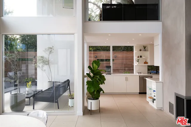 a living room with furniture and potted plant