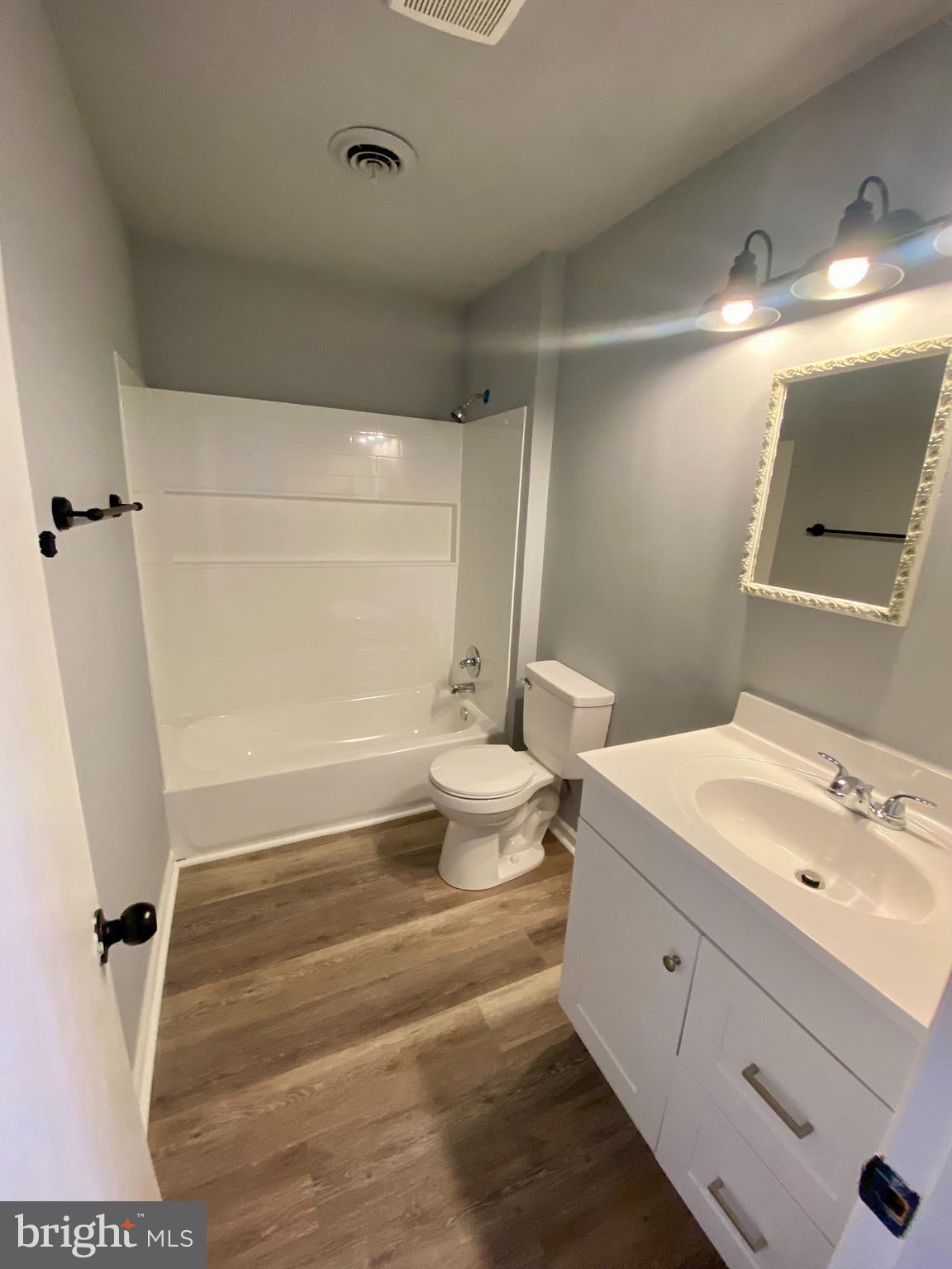 1417 Dandridge Street, Unit C Fredericksburg, VA 22401 - Photo 4 of 10 a bathroom with a sink a toilet a tub and shower