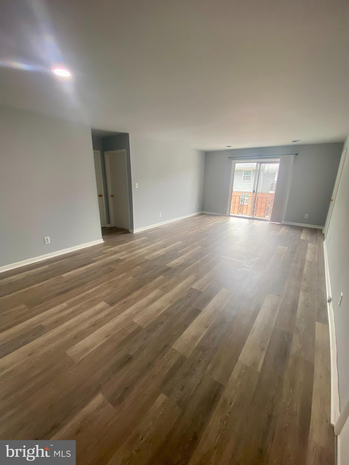 1417 Dandridge Street, Unit C Fredericksburg, VA 22401 - Photo 5 of 10 a view of an empty room with window and wooden floor