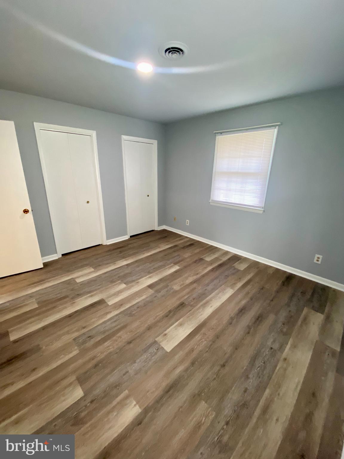 1417 Dandridge Street, Unit C Fredericksburg, VA 22401 - Photo 6 of 10 a view of an empty room with wooden floor and a window