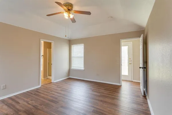a view of room with window and wooden floor