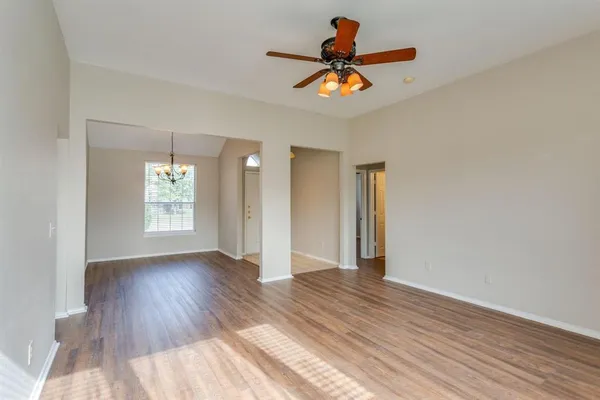 wooden floor in an empty room with a window