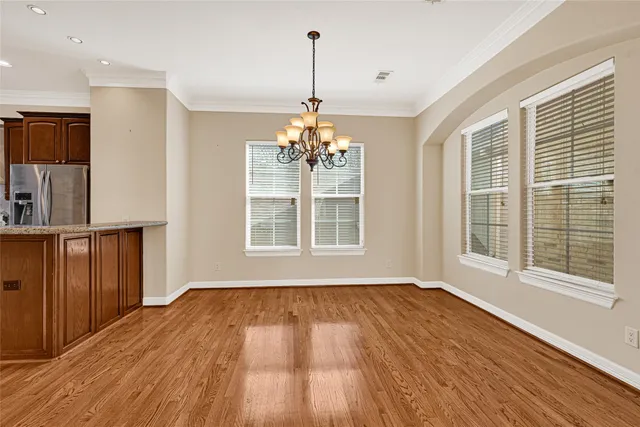 a bedroom with a bed mirror and window