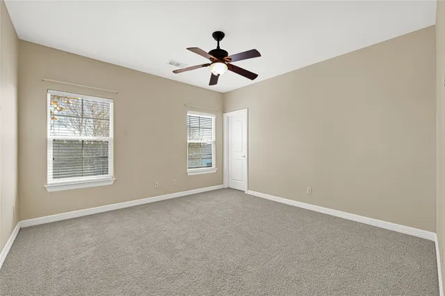 a kitchen with stainless steel appliances cabinets and a large window