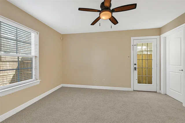 a view of a brick house with a yard and large trees