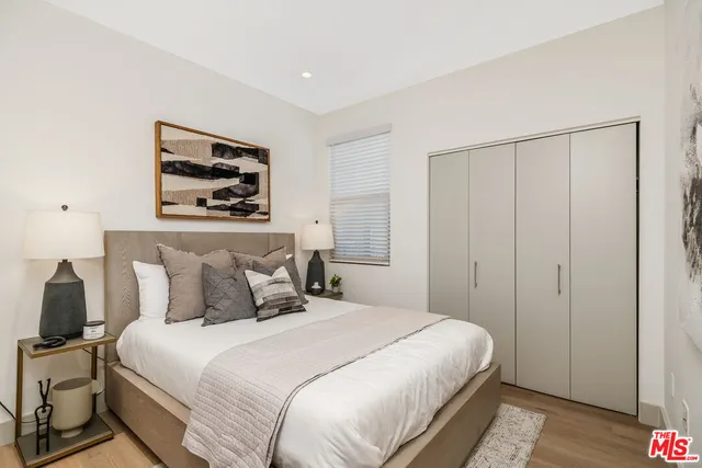 a bedroom with a bed and a painting on the wall