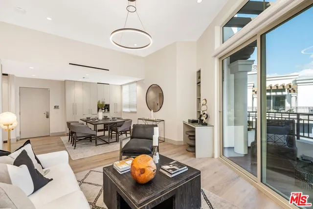 a living room with furniture a rug and a chandelier