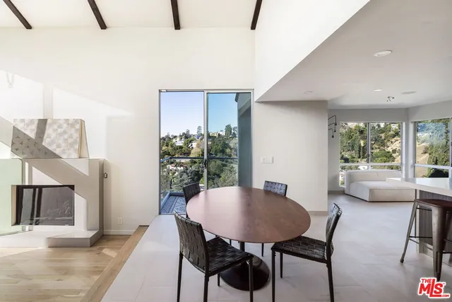 a view of a dining room with furniture and a potted plant