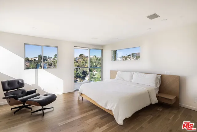a bedroom with a bed couch and a window